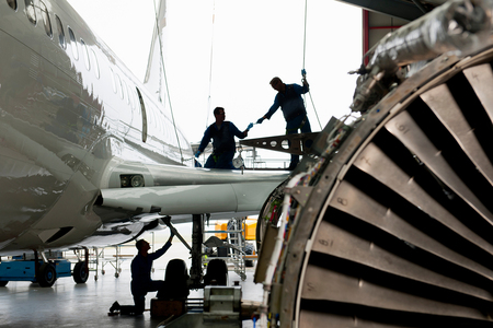 Mechanical Engineers working on an airplane StPh-k